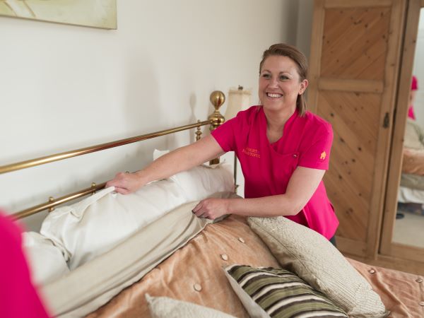 cleaner making a bed