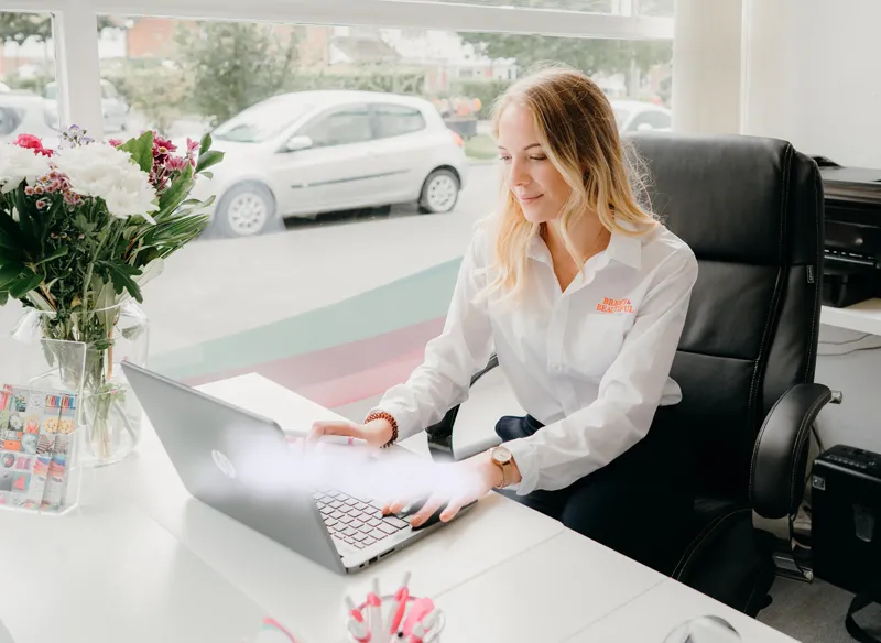 woman in an office working on a laptop