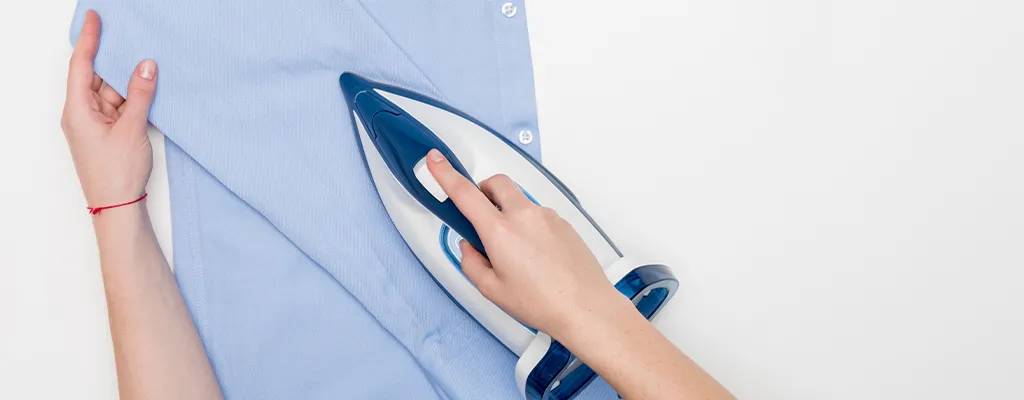 ironing a blue shirt