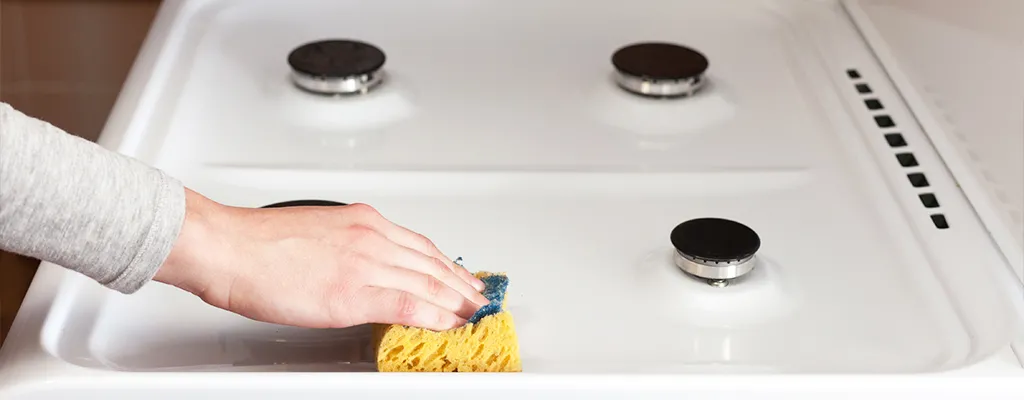 cleaning a hob with a sponge