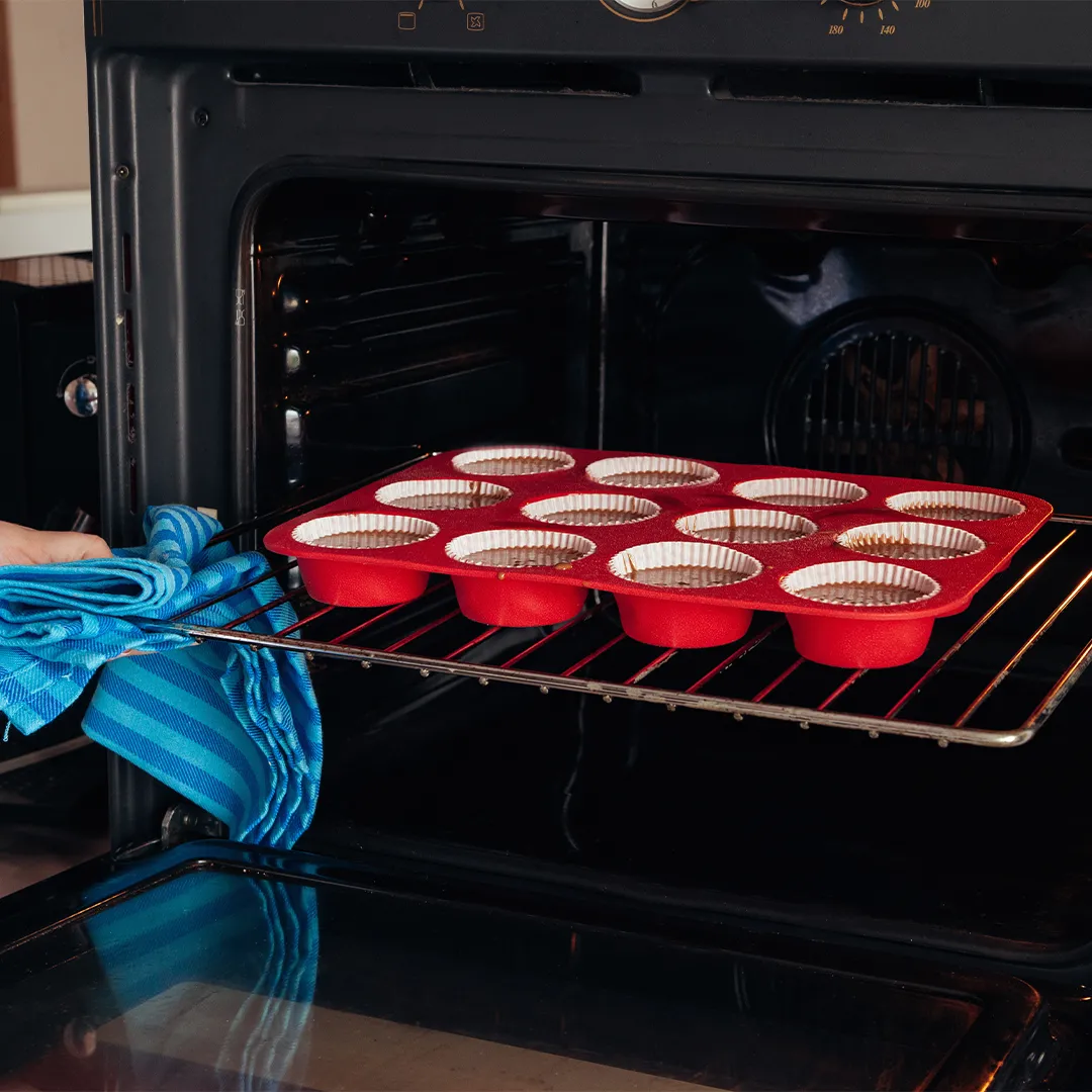 cupckaes on oven rack being put into oven