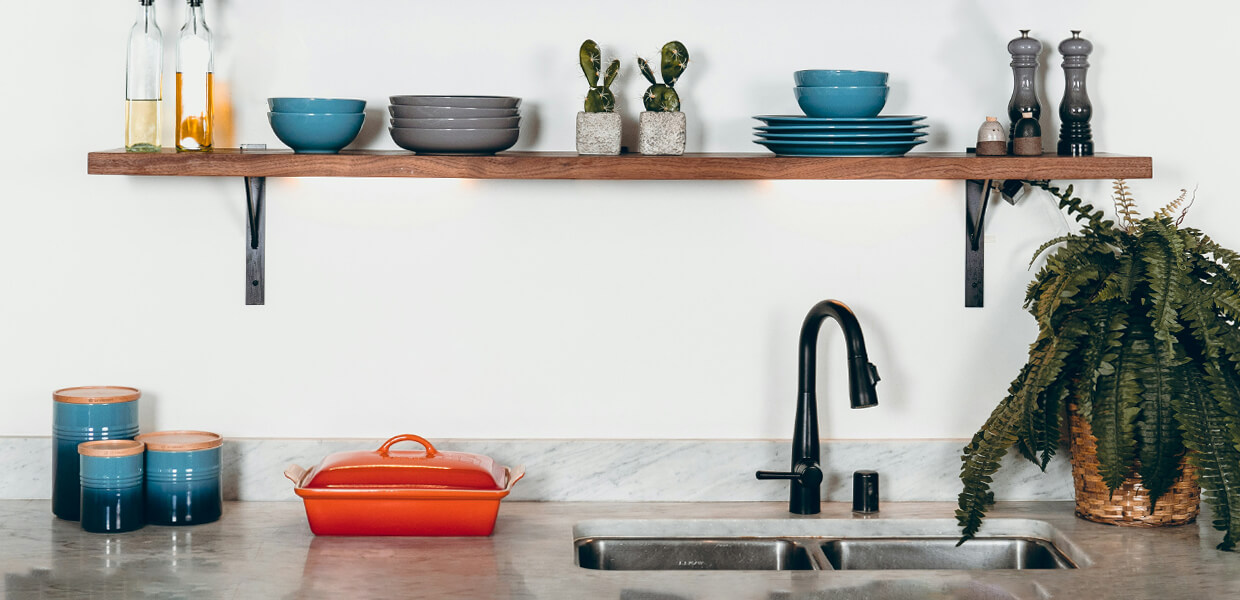 a clean marble kitchen worktop with rustic wooden shelving