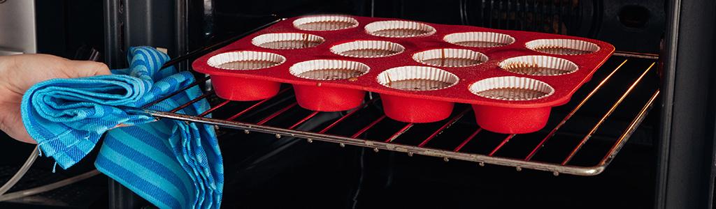 cupckaes on oven rack being put into oven
